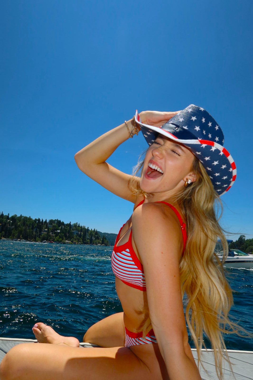 Bailey on the lake in a stars-and-stripes hat